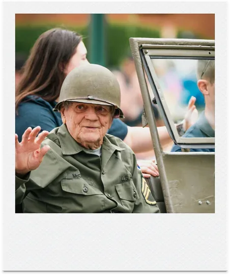 Veteran in uniform waving